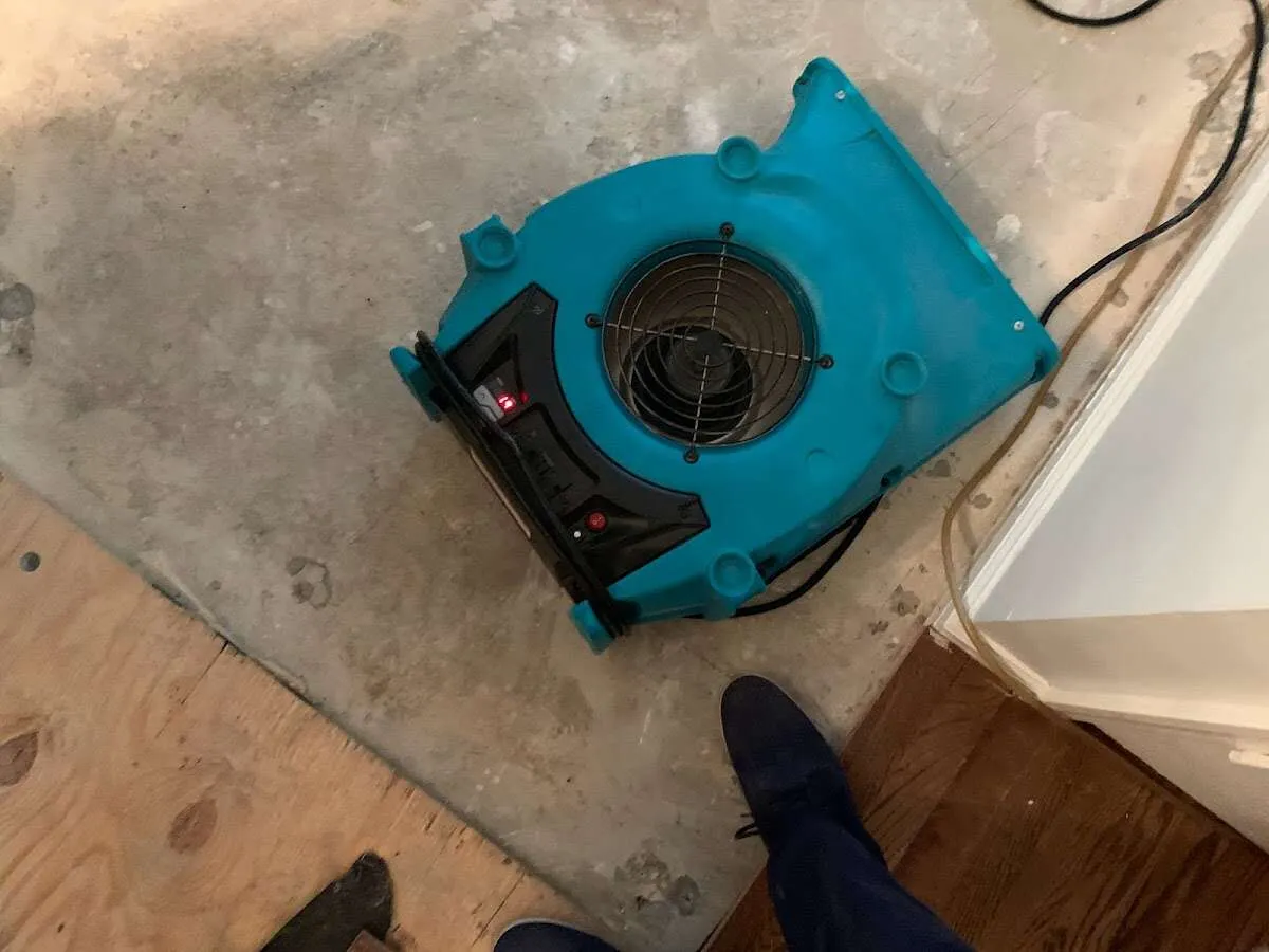 Air mover drying subfloor during Leak Detection & Repair in Mandan